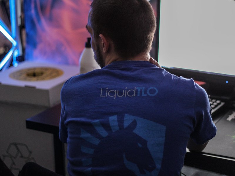 A single player seated at a lit gaming station during the overnight shift